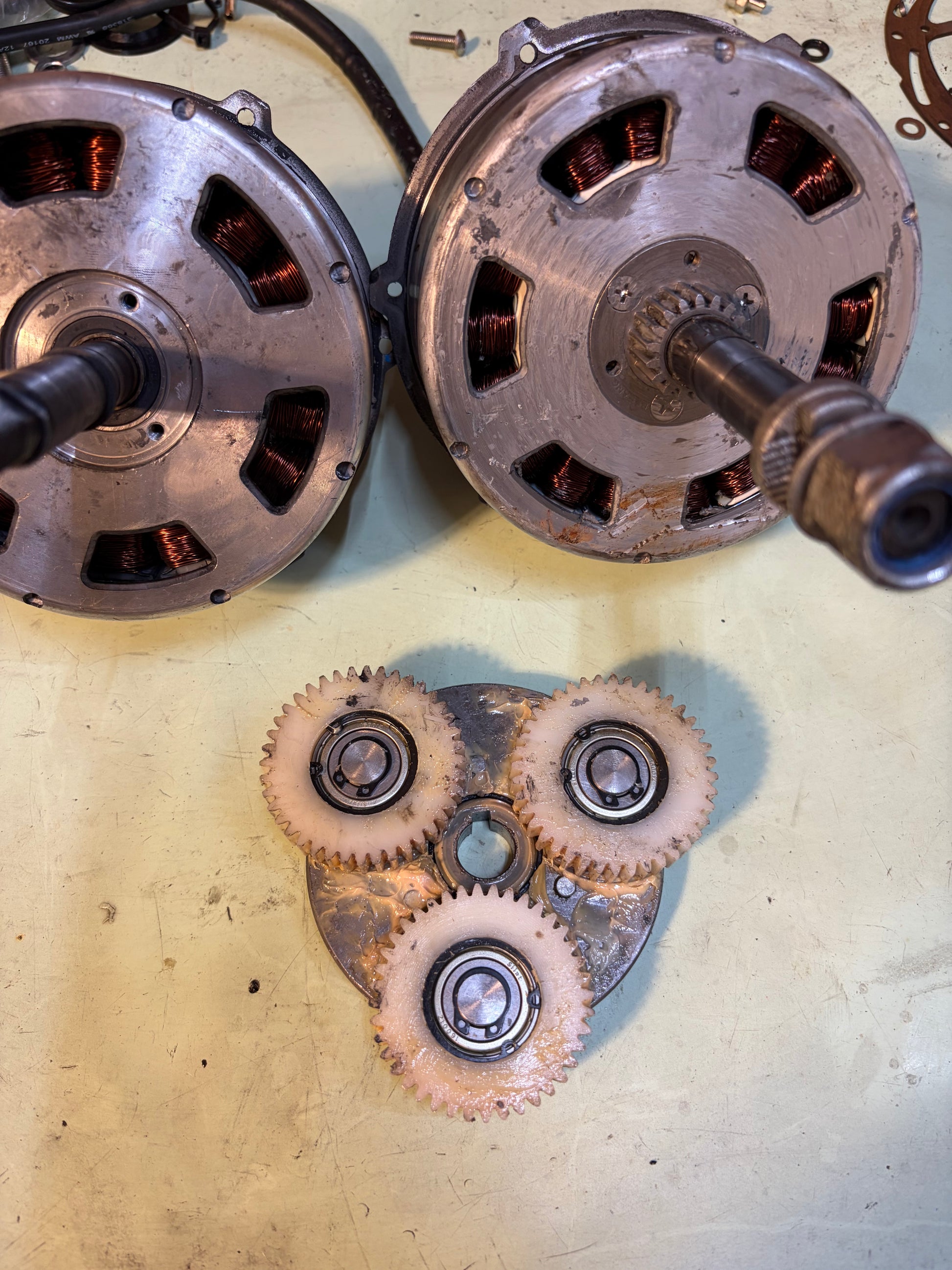 Internal view of a geared hub motor: two stators with copper windings and the nylon planetary gearset that wears out under load
