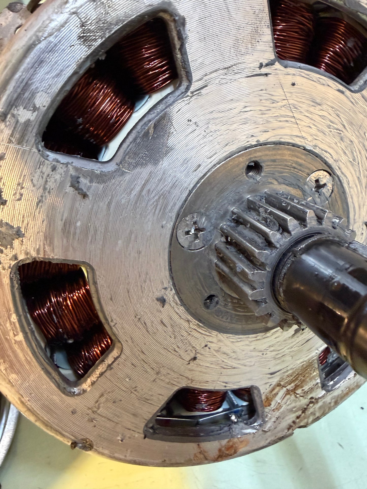 Close-up of a geared hub motor stator showing copper windings and the central drive gear